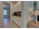 Convenient hallway showcasing abundant white cabinets with a modern backsplash at 2055 Quiet Cv, Sanford, FL 32771