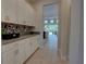 Spacious hallway leads to a view of the inviting back patio and pool area at 2055 Quiet Cv, Sanford, FL 32771