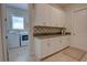 Well-equipped laundry room with ample storage, stylish backsplash, and natural light at 2055 Quiet Cv, Sanford, FL 32771