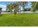 Large, grassy backyard enclosed by a pristine white fence, offering ample space at 2341 Oleander Rd, Deland, FL 32724