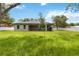 Spacious backyard featuring a lush lawn, privacy fence, and modern home exterior at 2341 Oleander Rd, Deland, FL 32724
