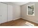 Empty bedroom with hardwood floors, double door closet, and a window view at 2341 Oleander Rd, Deland, FL 32724