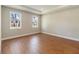 Bright bedroom with hardwood floors, two windows offering views, and ample space at 2341 Oleander Rd, Deland, FL 32724