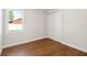 Cozy bedroom with wood flooring, a window, and a closet with white bi-fold doors at 2341 Oleander Rd, Deland, FL 32724