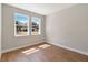 Bright bedroom featuring wood floors, two windows overlooking the front yard at 2341 Oleander Rd, Deland, FL 32724