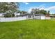 A well-maintained home showcasing lush green grass and a secure white fence at 2341 Oleander Rd, Deland, FL 32724