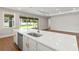 Modern kitchen island with quartz countertop, stainless steel appliances, and a view of the backyard at 2341 Oleander Rd, Deland, FL 32724