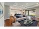 Comfortable living room featuring a plush sofa, stylish decor, and open access to the kitchen at 2341 Oleander Rd, Deland, FL 32724