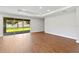 Spacious living room featuring wood floors and sliding glass doors to the backyard at 2341 Oleander Rd, Deland, FL 32724