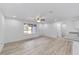 Bright living room featuring wood-look floors and a large window that provides ample natural light at 23741 Sw Blueberry Ln, Dunnellon, FL 34431