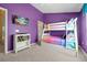 Fun bunk beds sit against purple walls with television in this bright bedroom in vacation rental at 2546 Maneshaw Ln, Kissimmee, FL 34747