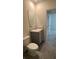 Bathroom featuring a sink and toilet with gray tile flooring at 2597 Shamrock St, Tavares, FL 32778