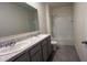 A bathroom with tile floors, a dual sink vanity, and a shower and tub combo at 2597 Shamrock St, Tavares, FL 32778