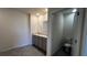 Neutral bathroom features a double vanity, tile floors, and toilet in a separate room at 2597 Shamrock St, Tavares, FL 32778