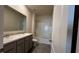 Neutral bathroom featuring a double vanity, tile floors, toilet, and shower/tub combo at 2597 Shamrock St, Tavares, FL 32778