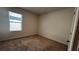 Bright bedroom with tan carpet and a window that lets in natural light at 2597 Shamrock St, Tavares, FL 32778