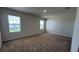 Bedroom with carpeted floor and two windows at 2597 Shamrock St, Tavares, FL 32778