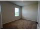 Bedroom featuring neutral walls, carpeted floors, and a bright window at 2597 Shamrock St, Tavares, FL 32778