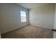 Inviting carpeted bedroom with natural light from window at 2597 Shamrock St, Tavares, FL 32778