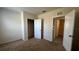 Bedroom with carpeted floor and doors to the bathroom and closet at 2597 Shamrock St, Tavares, FL 32778