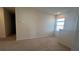 An upstairs bonus room with neutral carpet and a bright window at 2597 Shamrock St, Tavares, FL 32778