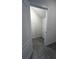 View into closet with gray tiled floor at 2597 Shamrock St, Tavares, FL 32778