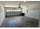 Spacious garage with white block walls and overhead door at 2597 Shamrock St, Tavares, FL 32778