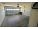 Two car garage with interior cinder block walls and concrete flooring at 2597 Shamrock St, Tavares, FL 32778