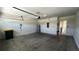 Spacious garage with white block walls and overhead door at 2597 Shamrock St, Tavares, FL 32778