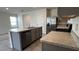 Bright kitchen features a stainless steel refrigerator, light gray cabinets and countertops at 2597 Shamrock St, Tavares, FL 32778