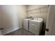 White washer and dryer units with wire rack shelving above, situated on tile floors at 2597 Shamrock St, Tavares, FL 32778