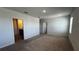 View of the main bedroom with carpeted floor leading to the Primary bath at 2597 Shamrock St, Tavares, FL 32778