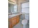 Bright bathroom with a large mirror, and a white toilet and sink with ample counter space at 2742 Rio Grande Trl, Kissimmee, FL 34741