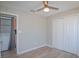 Bedroom featuring neutral walls, closet with white doors, adjacent laundry room, and light wood colored floors at 2742 Rio Grande Trl, Kissimmee, FL 34741