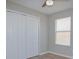 Bedroom with neutral walls, light wood colored floors, large closet with white doors and a window at 2742 Rio Grande Trl, Kissimmee, FL 34741