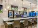 Stylish bar interior with modern lighting, comfortable seating, and multiple screens for sports and entertainment at 3044 Mahalo Dr, Davenport, FL 33897