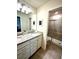 Bathroom featuring double sinks with granite countertops and a glass-enclosed shower at 3044 Mahalo Dr, Davenport, FL 33897