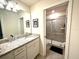 Bathroom featuring a single sink with granite countertops and a glass-enclosed shower at 3044 Mahalo Dr, Davenport, FL 33897