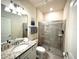 Bathroom featuring a glass-enclosed shower, granite vanity top, and modern fixtures at 3044 Mahalo Dr, Davenport, FL 33897