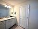 Simple bathroom with a granite vanity top, light fixture and a large mirror at 3044 Mahalo Dr, Davenport, FL 33897