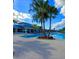 Expansive community pool area with sun loungers, umbrellas, and palm trees, offering a resort-style experience at 3044 Mahalo Dr, Davenport, FL 33897