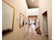 Bright hallway featuring tile flooring, high ceilings, and elegant wall decor leading into other rooms at 3044 Mahalo Dr, Davenport, FL 33897