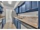 Galley kitchen features painted cabinetry, stainless appliances, and a tile floor at 311 E Morse Blvd # 6-7, Winter Park, FL 32789