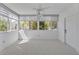 Light-filled sunroom with multiple windows, white trim, and carpet flooring at 311 E Morse Blvd # 6-7, Winter Park, FL 32789