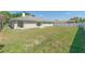 Spacious backyard with healthy green lawn and a white vinyl fence and sliding glass doors at 323 Shadow Oak Dr, Casselberry, FL 32707