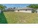 Large, grassy backyard featuring privacy fence and sliding glass doors leading inside at 323 Shadow Oak Dr, Casselberry, FL 32707