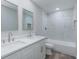 Modern bathroom with dual vanity, quartz countertop, and tiled shower/tub combo at 323 Shadow Oak Dr, Casselberry, FL 32707