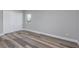 A bright bedroom featuring wood-look floors, a closet, and neutral decor at 323 Shadow Oak Dr, Casselberry, FL 32707