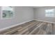 Bright bedroom features natural light, neutral walls, and sleek wood-look flooring at 323 Shadow Oak Dr, Casselberry, FL 32707