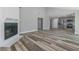 Bright living room with vaulted ceiling, fireplace and sleek modern floors that lead into the kitchen at 323 Shadow Oak Dr, Casselberry, FL 32707